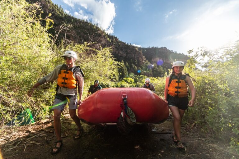 Guests carry boat to Colorado River